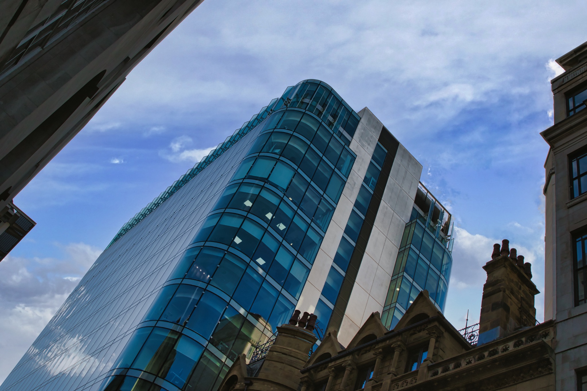 Modern Skyscraper with Historic Building in Manchester, UK.